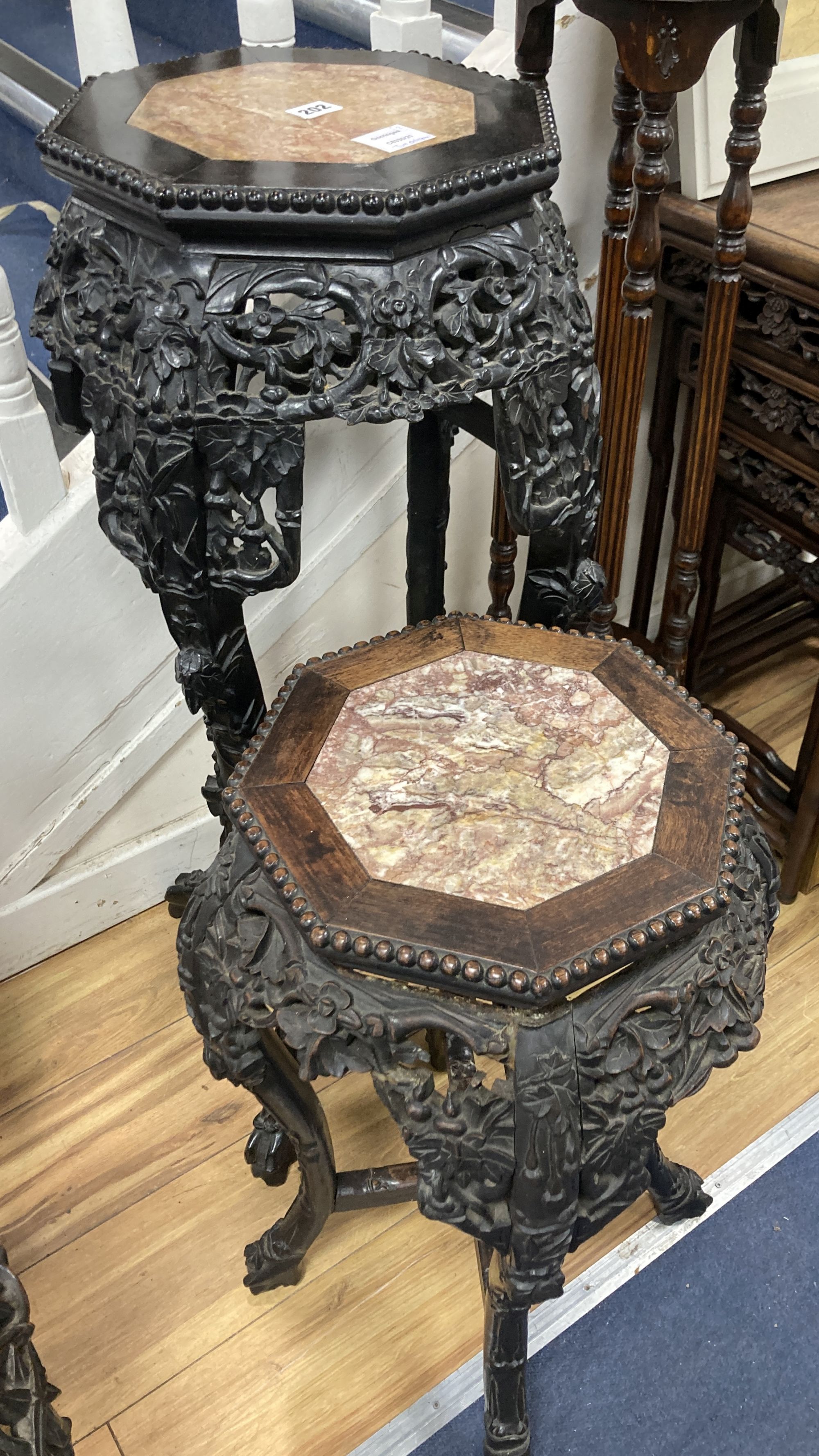 Two Chinese hongmu and marble inset octagonal stands, late 19th century, largest width 40cm height 90cm